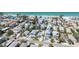 The perfect coastal neighborhood showing the home, mature landscaping, and stunning proximity to the beach at 2408 Avenue B, Bradenton Beach, FL 34217