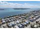 Stunning aerial view of a coastal home with a pool, surrounded by clear waters and beautiful waterfront neighborhood at 2408 Avenue B, Bradenton Beach, FL 34217