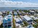Aerial view of a neighborhood showcasing diverse homes with ocean views at 2408 Avenue B, Bradenton Beach, FL 34217