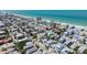 Scenic aerial view of a charming coastal home surrounded by colorful residences and palm tree-lined streets at 2408 Avenue B, Bradenton Beach, FL 34217