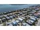Aerial view of a quaint coastal home with a private pool nestled among colorful neighborhood homes at 2408 Avenue B, Bradenton Beach, FL 34217