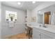 Bright bathroom with a large vanity, a stool, decorative touches, and unique window at 2408 Avenue B, Bradenton Beach, FL 34217