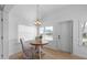 Cozy dining area with a wooden table, chandelier lighting, and bright windows at 2408 Avenue B, Bradenton Beach, FL 34217