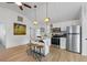 Modern kitchen features stainless steel appliances, a breakfast bar, and white cabinetry at 2408 Avenue B, Bradenton Beach, FL 34217