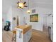 Open-concept kitchen with island, white cabinetry, and stainless steel appliances at 2408 Avenue B, Bradenton Beach, FL 34217