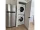 Convenient stacked washer and dryer in closet, next to a stainless steel refrigerator at 2408 Avenue B, Bradenton Beach, FL 34217