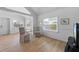 Bright living room features wood floors, wainscoting, and modern decor at 2408 Avenue B, Bradenton Beach, FL 34217