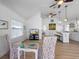 Open living space with vaulted ceilings, ceiling fans, hardwood floors, and views into the kitchen at 2408 Avenue B, Bradenton Beach, FL 34217