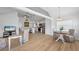 Open-concept living and dining area featuring hardwood floors, vaulted ceilings, and abundant natural light at 2408 Avenue B, Bradenton Beach, FL 34217