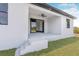 A covered back porch with a ceiling fan and entry to the home at 302 Liden St, Port Charlotte, FL 33953