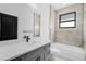 Modern bathroom featuring vanity, large mirror, and shower/tub combo at 302 Liden St, Port Charlotte, FL 33953