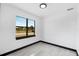 A simple bedroom with tile flooring, a window view, and natural light, offering a bright and airy space at 302 Liden St, Port Charlotte, FL 33953