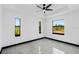 Well-lit bedroom with ceiling fan, recessed lighting, and scenic outdoor views at 302 Liden St, Port Charlotte, FL 33953