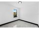 Empty bedroom featuring tile flooring, a single window view, and recessed lighting for a modern touch at 302 Liden St, Port Charlotte, FL 33953