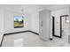 The dining room features a modern pendant light, large window, tile flooring, and access to the bathroom and pantry at 302 Liden St, Port Charlotte, FL 33953