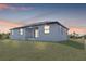 Rear exterior of a home with a covered porch at sunset at 302 Liden St, Port Charlotte, FL 33953