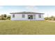 Lawn view of a home with a covered porch and three windows at 302 Liden St, Port Charlotte, FL 33953