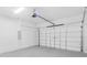 Spacious two-car garage with painted floor and white door at 302 Liden St, Port Charlotte, FL 33953
