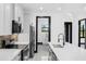 Modern kitchen featuring white cabinets, stainless steel appliances, and an island with a sink at 302 Liden St, Port Charlotte, FL 33953