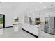 Bright, open kitchen featuring white cabinets, a kitchen island, and stainless steel appliances at 302 Liden St, Port Charlotte, FL 33953