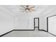 Bright living room featuring decorative alcoves, ceiling fan, and glass sliding doors at 302 Liden St, Port Charlotte, FL 33953