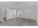 Spacious bedroom with wood-look floors, white trim, and en-suite bathroom at 3751 S School Ave # 9, Sarasota, FL 34239