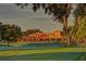 Golf course clubhouse featuring a large covered porch with views of the green at 405 Magellan Dr, Sarasota, FL 34243