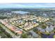 Aerial view of houses in community surrounding a lake and green space at 4302 Turnberry Ct, Bradenton, FL 34210