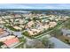 An aerial view of the neighborhood showcases lush landscaping, lakes, and well-maintained homes at 4302 Turnberry Ct, Bradenton, FL 34210