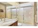 Full bathroom with white tub and glass doors, with granite counter and vanity at 4302 Turnberry Ct, Bradenton, FL 34210