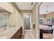 Bathroom featuring granite counters, double sinks, and a shower in a bright, neutral space at 4302 Turnberry Ct, Bradenton, FL 34210