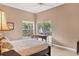 Bright bedroom featuring neutral walls, ceiling fan and view of the exterior patio at 4302 Turnberry Ct, Bradenton, FL 34210