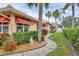 Landscaped yard featuring a winding walkway and lush greenery adds to this home's curb appeal at 4302 Turnberry Ct, Bradenton, FL 34210