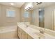 Bright bathroom features double sinks, a large mirror, a shower, and a soaking tub at 4656 72Nd E Ct, Bradenton, FL 34203