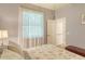 Bright bedroom features a window, wood flooring, and an en-suite bathroom at 4656 72Nd E Ct, Bradenton, FL 34203