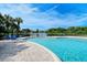 Gorgeous community pool providing lake views and a great lounging area with chairs and lush vegetation at 4656 72Nd E Ct, Bradenton, FL 34203