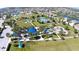 Aerial view of a green park area with tennis courts and recreational area at 4718 Claremont Park Dr, Bradenton, FL 34211