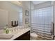 Bathroom featuring dark wood vanity with white counter and shower with striped curtain at 4718 Claremont Park Dr, Bradenton, FL 34211