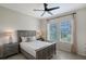 Comfortable bedroom featuring stylish furnishings, natural light from two windows, and a ceiling fan at 4718 Claremont Park Dr, Bradenton, FL 34211