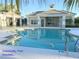 Beautiful community pool area featuring lounging spaces, shaded cabanas, and crystal-clear waters for relaxation and recreation at 4718 Claremont Park Dr, Bradenton, FL 34211