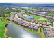 Overhead view of a housing community with a golf course and a large lake at 4719 Cabreo Ct, Bradenton, FL 34211