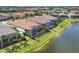 Beautiful aerial view of homes with screened-in pools next to a picturesque lake at 4719 Cabreo Ct, Bradenton, FL 34211