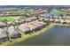 Aerial view of a residential community with a golf course and lake at 4719 Cabreo Ct, Bradenton, FL 34211