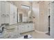 Modern bathroom showcasing granite countertops, white cabinets, and a large decorative mirror at 4719 Cabreo Ct, Bradenton, FL 34211