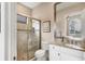 Bathroom featuring tile shower with glass door, toilet, vanity, sink, and granite countertops at 4719 Cabreo Ct, Bradenton, FL 34211