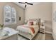 Cozy bedroom featuring a beautiful window with shutters and a comfortable queen-sized bed at 4719 Cabreo Ct, Bradenton, FL 34211