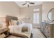 Comfortable bedroom with a window view and a vintage dresser complemented by a wooden, carved-style bed frame at 4719 Cabreo Ct, Bradenton, FL 34211