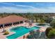 Aerial view of the resort-style community pool with lounging areas, mature landscaping, and inviting shade at 4719 Cabreo Ct, Bradenton, FL 34211