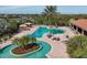 Aerial view of a stunning community pool with lazy river, lush landscaping, and ample seating at 4719 Cabreo Ct, Bradenton, FL 34211