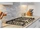 Modern cooktop with marble backsplash and stainless steel appliances for a sleek kitchen design at 4719 Cabreo Ct, Bradenton, FL 34211